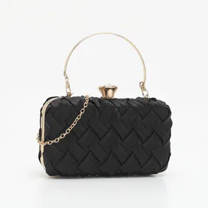 Black woven evening clutch bag with gold round handle and delicate chain strap detail.