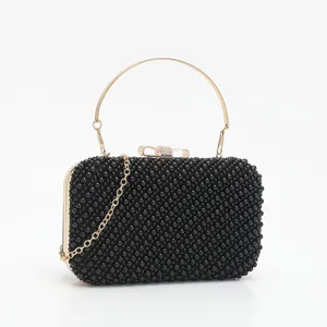 Exquisite black beaded evening clutch bag featuring a sleek gold metal handle and delicate chain.