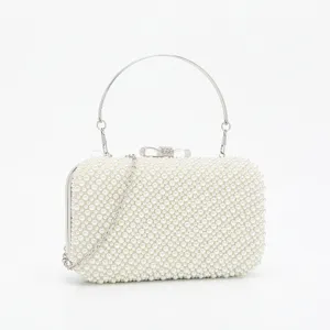 Elegant pearl evening clutch bag with metal ring handle and chain for women evening parties.