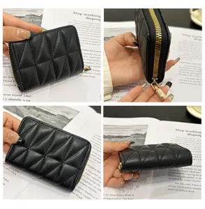 Black quilted card holder with luxury gold zipper, accordion design for multi-card storage.