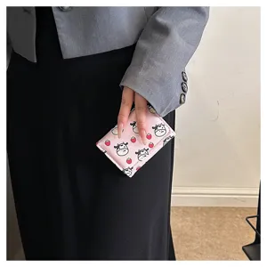 Pink trifold wallet with cute cow and strawberry print, compact mini card holder for women.
