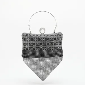 Exquisite rhinestone evening clutch featuring sparkling crystals, metal handle and unique design.