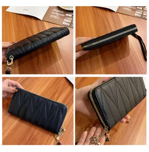 Women black quilted long wallet zipper clutch purse with wristlet strap and cute clover charm.