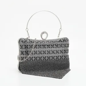 Exquisite rhinestone evening clutch detail, black crystal design with metal ring top handle.