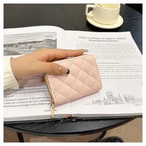 Pink quilted card holder detail, featuring soft faux leather and a secure gold zipper.