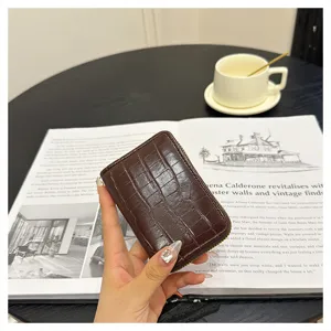 Close-up view of the brown crocodile pattern zip card holder showcasing compact slots.
