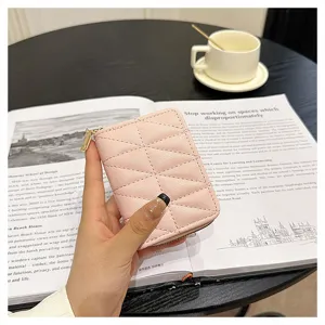 Pink quilted card holder detail shot, accordion wallet design with zipper and multi slots.