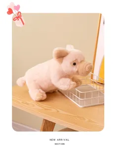 Cute pink plush pig toy detail view, soft stuffed animal sitting on wooden desk scene.