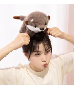 Cute plush otter toy detail view showing the soft brown animal doll worn or placed nicely on head by a model.
