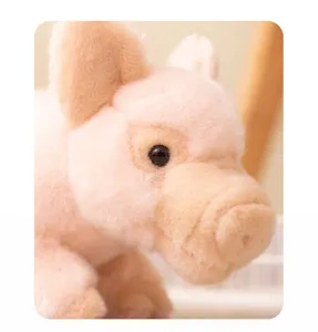 Close-up detail of soft pink plush pig toy, showing fluffy texture and cute design.