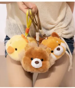 Cute plush animal keychain detail showcasing soft fabric, lovely chick and bear doll pendants.