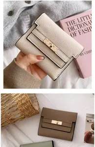 Detailed view of women short folding wallet with metal turn-lock clasp and card slots.