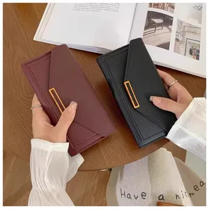 Detailed view of women's long wallet with elegant metal clasp and textured leather finish.