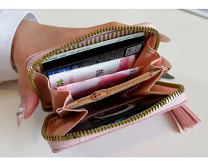 Detail view of a cute pink PU leather short wallet with inner card slots and zipper pocket.