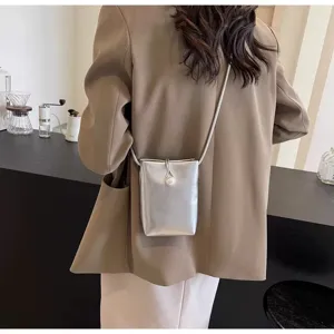 Stylish silver phone crossbody bag for women, chic pearl closure mini shoulder bag for summer.