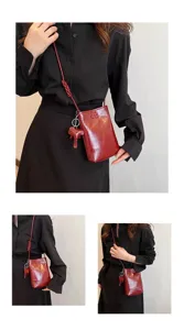 Wine red mini phone bag with cute elephant pendant, stylish crossbody shoulder bag.