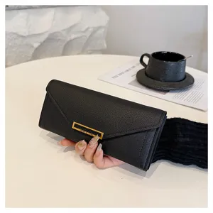 Detail view of black long wallet with metal buckle in minimalist style, elegant design.