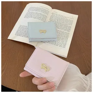 Detailed view of women short wallet with cute metal bow decoration, multi-card slots.