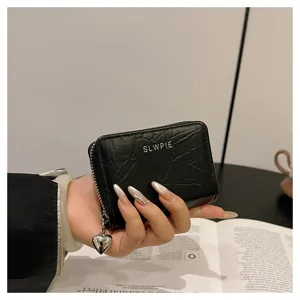 Mini black PU leather wallet with cute heart pendant and card slots for women and girls daily use.