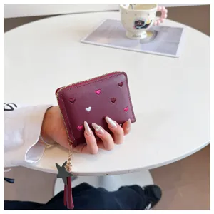 Red PU leather short wallet for women with cute heart embroidery and star tassel pendant.