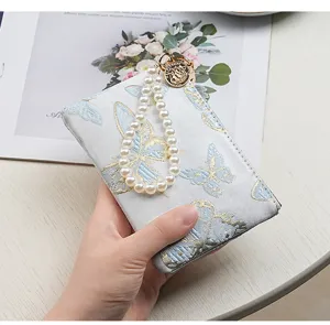 Chic embroidered butterfly wallet with pearl hand strap, elegant card holder phone bag detail view.