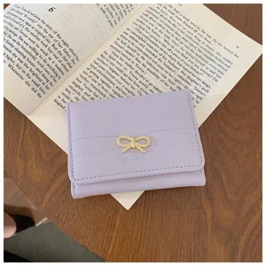 Purple short wallet detail close-up, cute bow decor, minimalist card holder coin purse style.