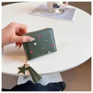 Short PU leather wallet with cute embroidered hearts, zipper closure, tassel and star pendant.