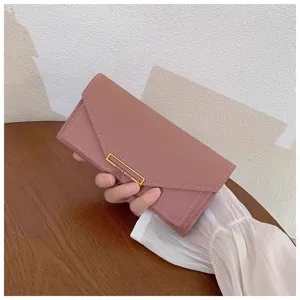 Close-up detail of the pink long wallet with gold metal clasp and envelope fold design.