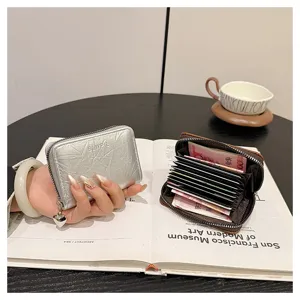 Compact zipper card holder and coin purse with cute heart pendant, multi-slot design for women.