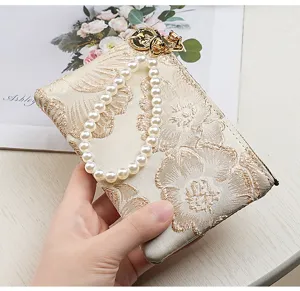 Chinese style embroidered wallet detail view, elegant pearl wrist strap, zipper coin card pouch.