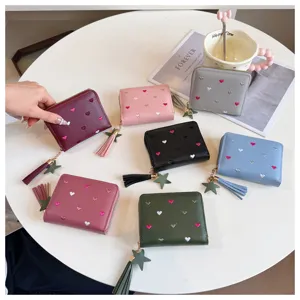 Short PU leather wallet with heart embroidery and tassel charm, cute compact coin purse for women.