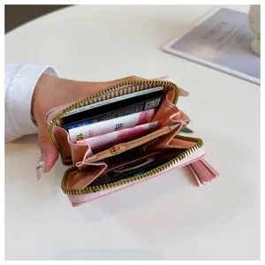 Detailed view of the pink PU leather wallet interior, showing card slots and zipper pocket.