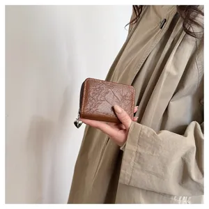 Compact brown leather card holder wallet with cute heart pendant, secure zipper closure for women.