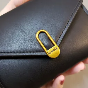 Stylish black short folding women's wallet with chic gold metal clasp and multiple card slots.