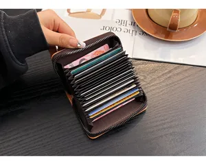 Vintage brown leather card holder wallet featuring multi card slots and secure zipper closure.