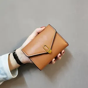 Brown short wallet for women, trifold PU leather card holder with metal buckle clasp, compact purse.