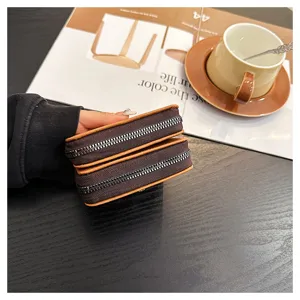 Detail view of the brown double-zipper leather card holder showing multi-card capacity.