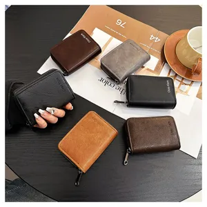Detailed view of multiple vintage zippered card holders in various colors on a dark table.