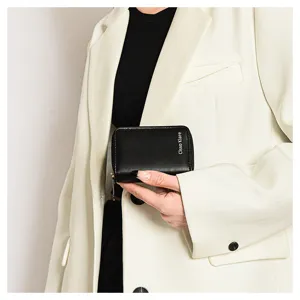Minimalist black leather card holder wallet for women, compact zipper pocket design.