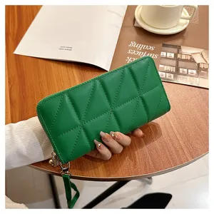 Green quilted long women's wallet with zipper, stylish clutch purse and wrist strap design.
