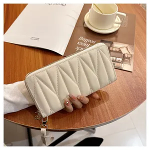 White quilted long wallet for women, stylish zip-around purse with wrist strap and spacious interior.