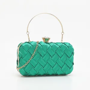Green woven evening clutch bag with gold metal round handle and crystal clasp for women.