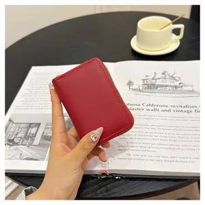 Red leather zipper card holder with compact design, multiple slots, and smooth metal closure.