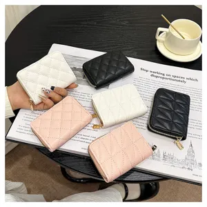 Detailed view of fashionable quilted leather card holders in multiple chic colors on a stylish table.