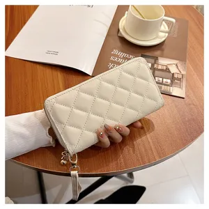 Women's quilted long wallet, stylish zip-around purse with wrist strap and elegant design.
