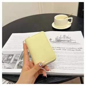 Compact yellow PU leather card holder and coin purse with zip closure, detail view.