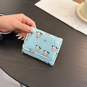Cute mini trifold wallet for women, blue short coin purse with cute cow pattern, compact ID card holder.