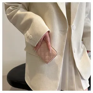 Exquisite quilted card holder detail showing soft pink leather texture and compact zipper design.