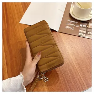 Quilted long wallet detail showcasing premium brown leather material and cute clover zipper charm.