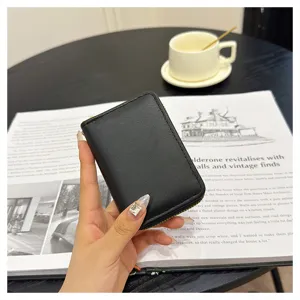 Elegant black leather zipper card holder for women, compact coin purse with detail view.